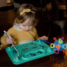 Child drawing on Spearmint Busy Baby Mat silicone mat at restaurant