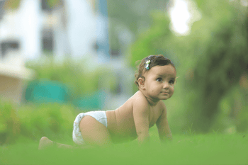 baby crawling in grass