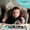 A baby sitting in a highchair playing with toys attached to Busy Baby Tethers and Mini Mat