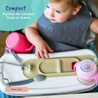 Baby in a high chair with a bib and Busy Baby Mini mat and accessories, featuring text about compactness.