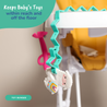 Toy bungee with a baby toy attached, hanging from a highchair tray.