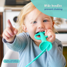 A baby sitting in a highchair chewing the Busy Baby 2-in-1 Teether & Training Spoon with a big smile